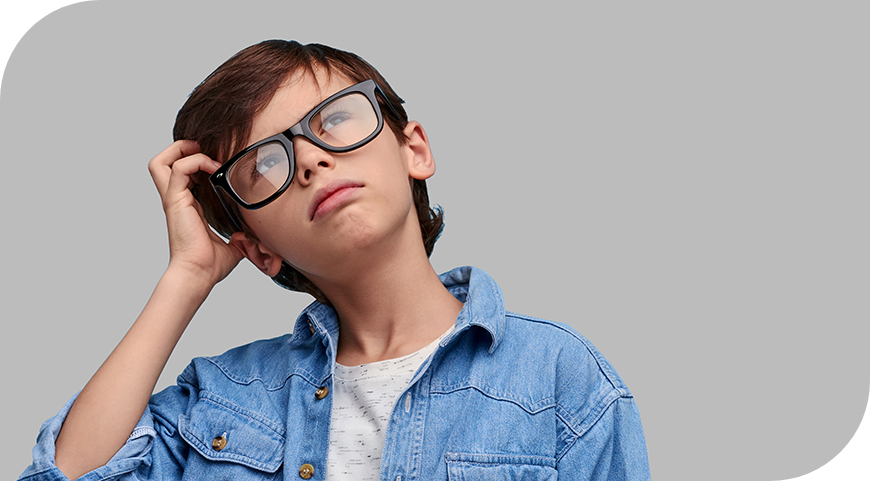 Young boy with glasses thinking