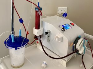 EBOO therapy machine at Bliss MD's clinic performing blood filtration and medical ozone therapy for a Palatine patient — authentic EBOO equipment with closed sterile circuit, blood filtration column, and medical ozone delivery system used by Dr. Anand Thakkar MD