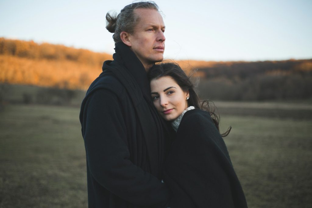 Functional medicine Downers Grove: couple embracing in an autumn meadow at golden hour