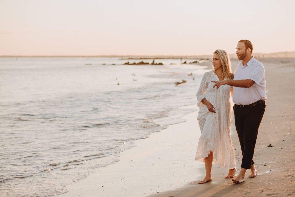 Functional medicine Evanston: couple in their late 40s walking along the shore at golden hour