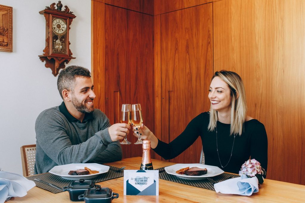Functional medicine Oak Brook: couple in their 40s sharing a dinner toast