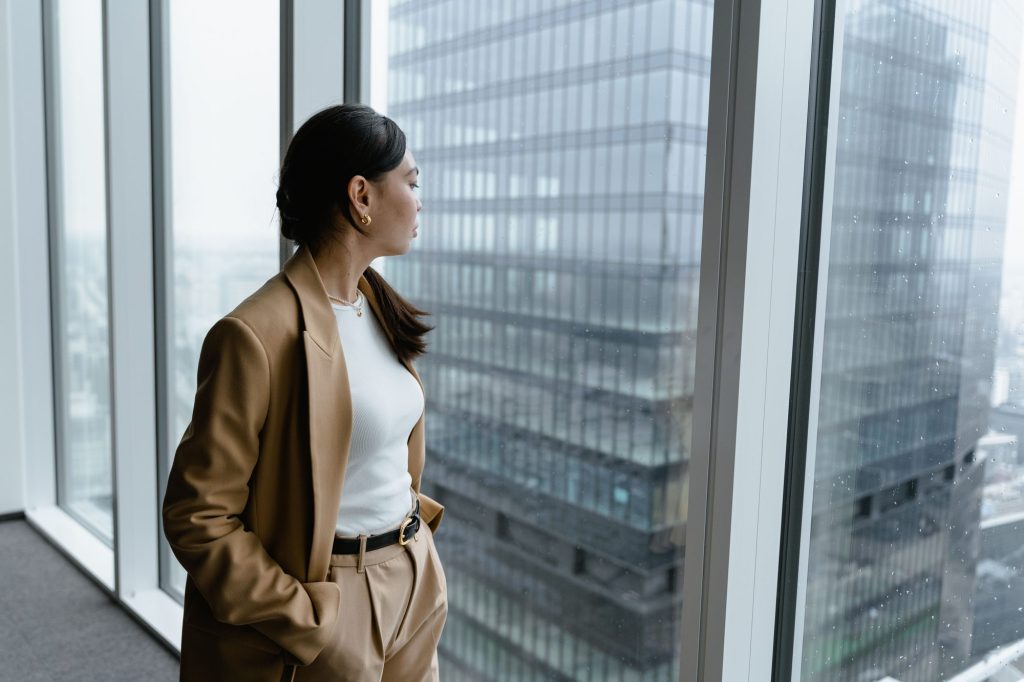 Hormone replacement therapy Chicago: confident woman by a glass office window