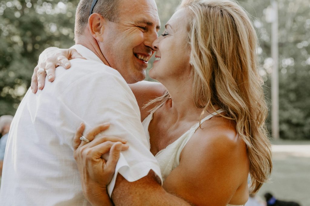 HRT Winnetka: couple in their late 40s sharing a close, laughing moment outdoors in a garden