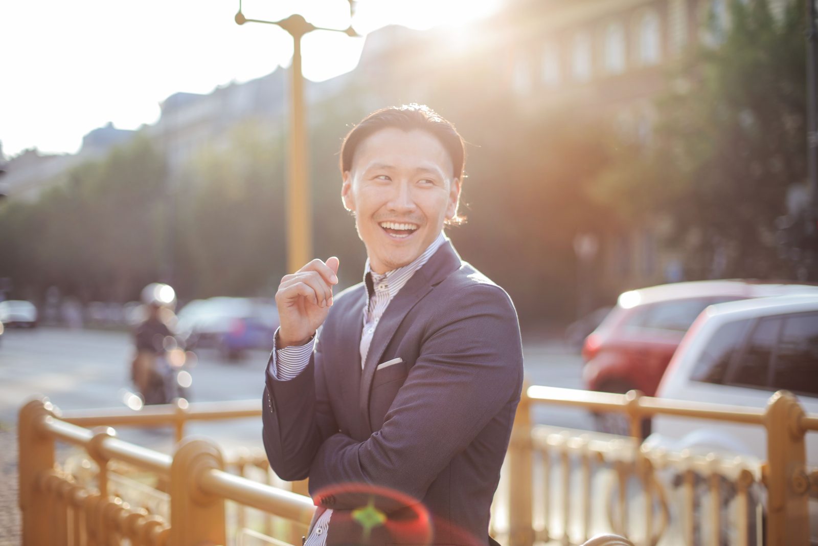 Is TRT safe: laughing man in a navy suit on a city street in warm sunset light