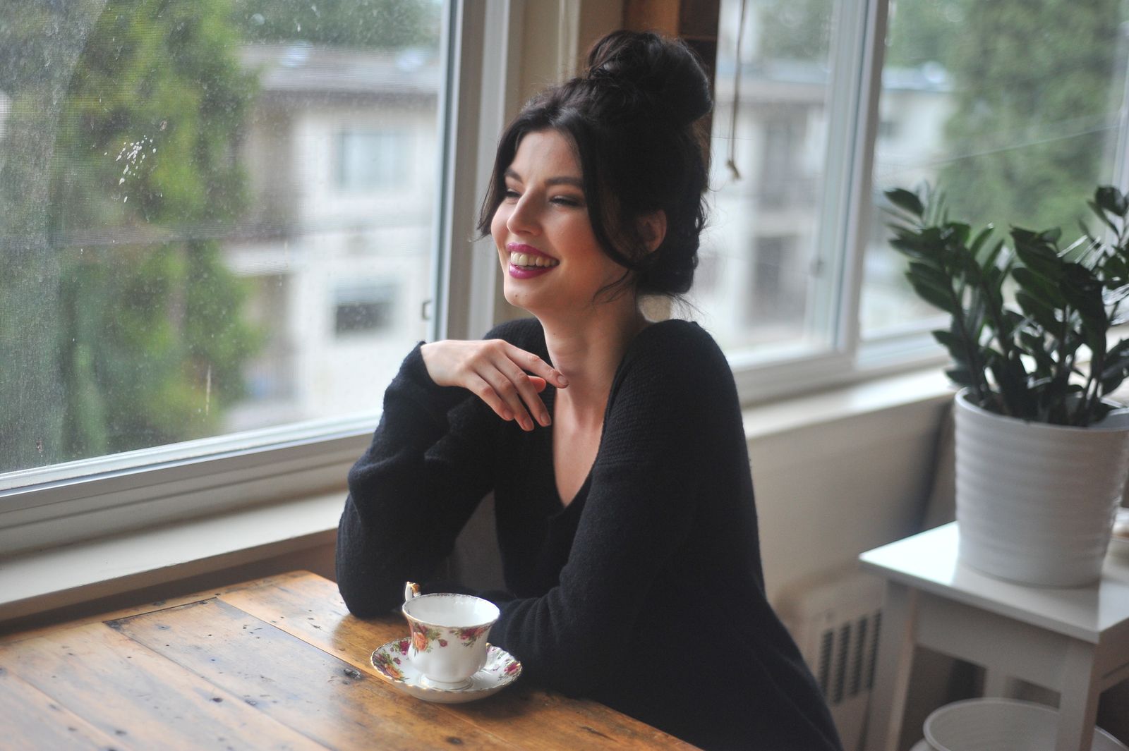 IV ketamine therapy Chicago: calm, smiling woman in her 40s seated by a bright window with a cup of tea