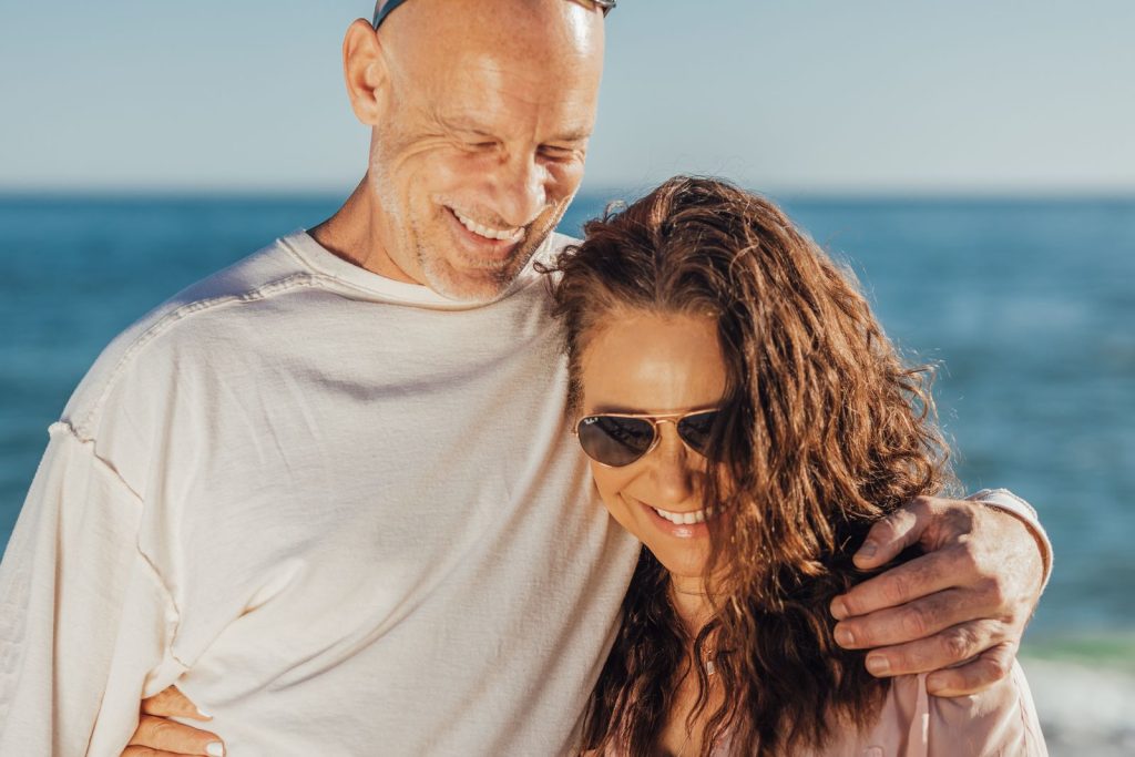 IV ketamine therapy Evanston: calm couple in their 50s sharing a quiet embrace by the lake