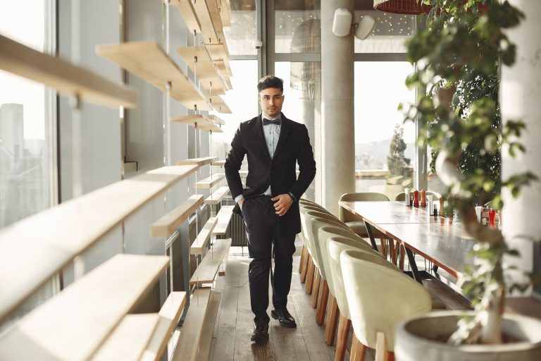 Low testosterone and ED: man in a tuxedo walking through an upscale restaurant