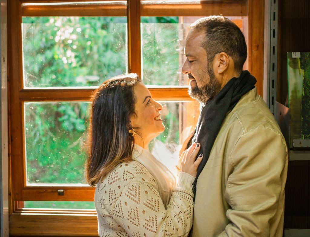 Low testosterone symptoms: couple sharing a warm moment by a window