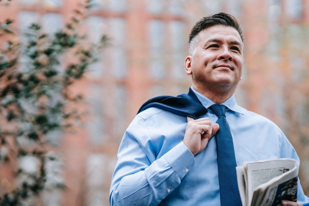 Low testosterone symptoms: smiling man in a blue shirt and tie