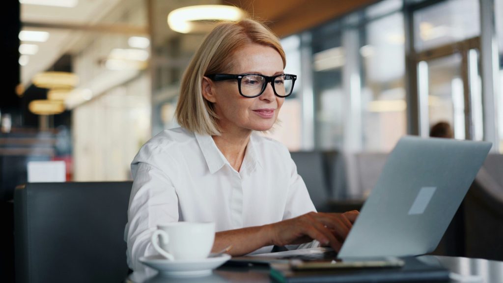 Menopause treatment options: woman working at a laptop in an upscale cafe