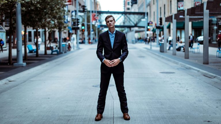 P Shot cost Chicago: man in a navy suit on an urban boulevard