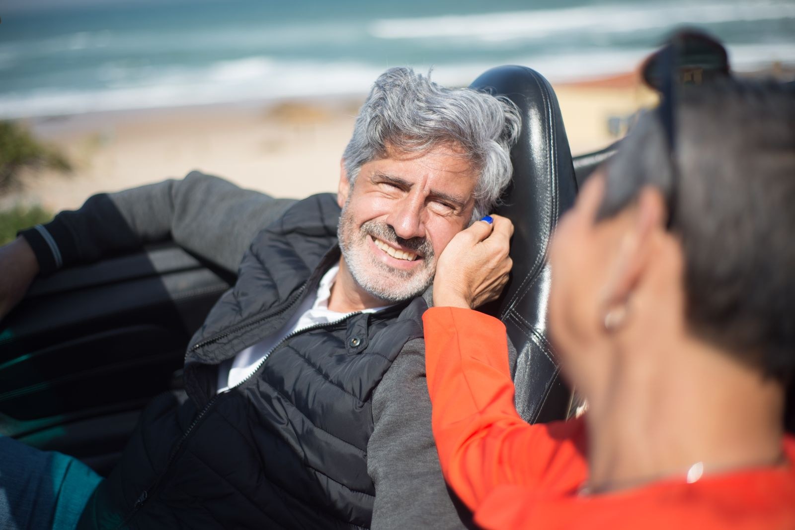 Quad mix injections in Chicago: silver-haired man laughing with his partner in a convertible by the water