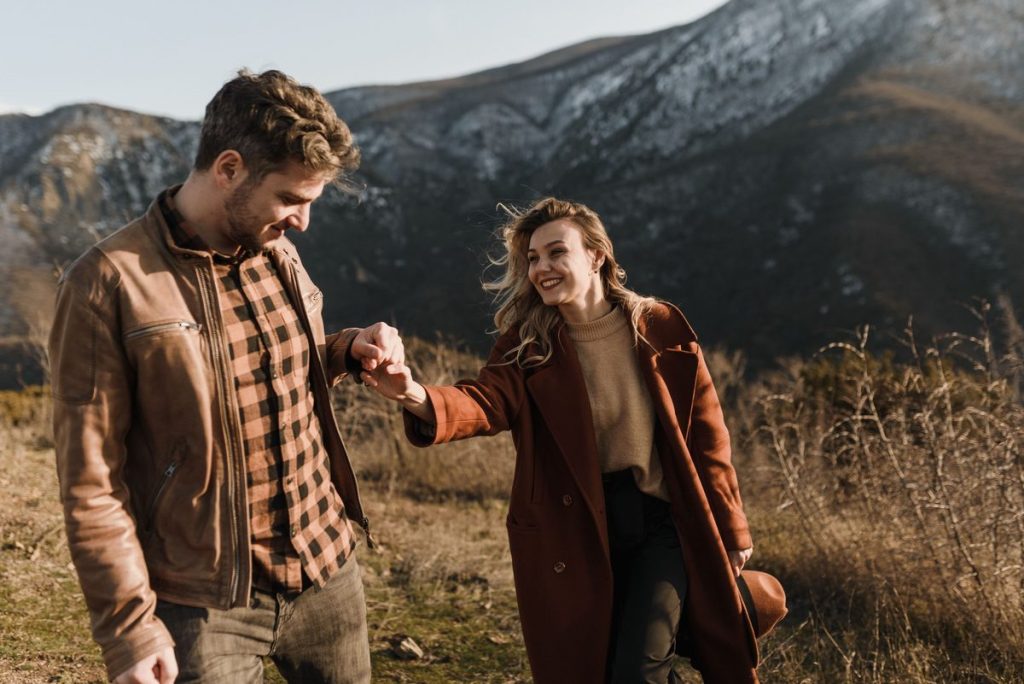 Smiling couple walking hand in hand outdoors in warm evening light, illustrating planning for testosterone therapy costs