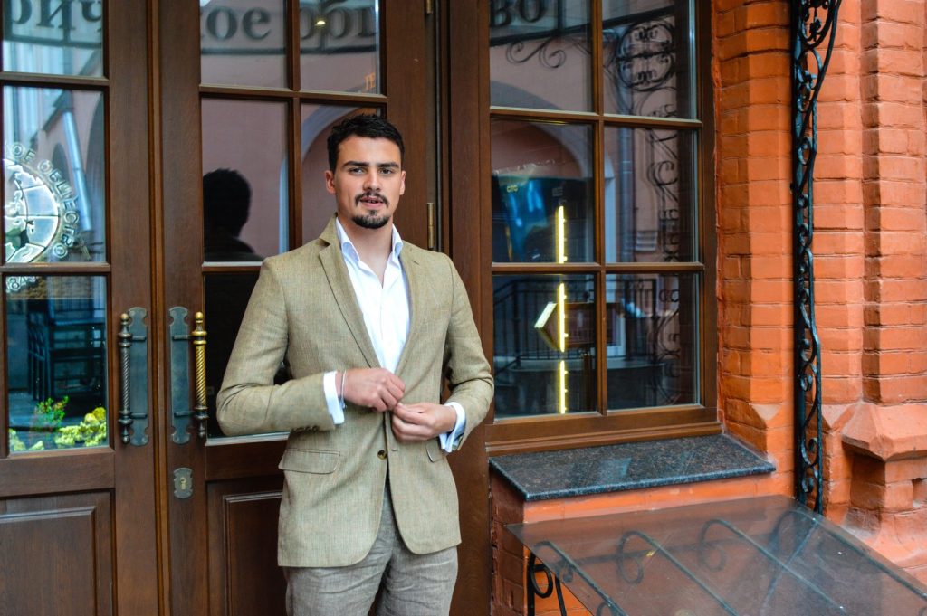TRT cost Chicago: man in a tan blazer and white shirt outside a classic café entrance